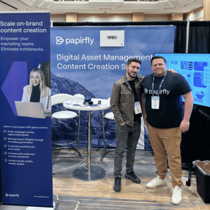 Papirfly team members at event booth showcasing Digital Asset Management and Content Creation Suite.