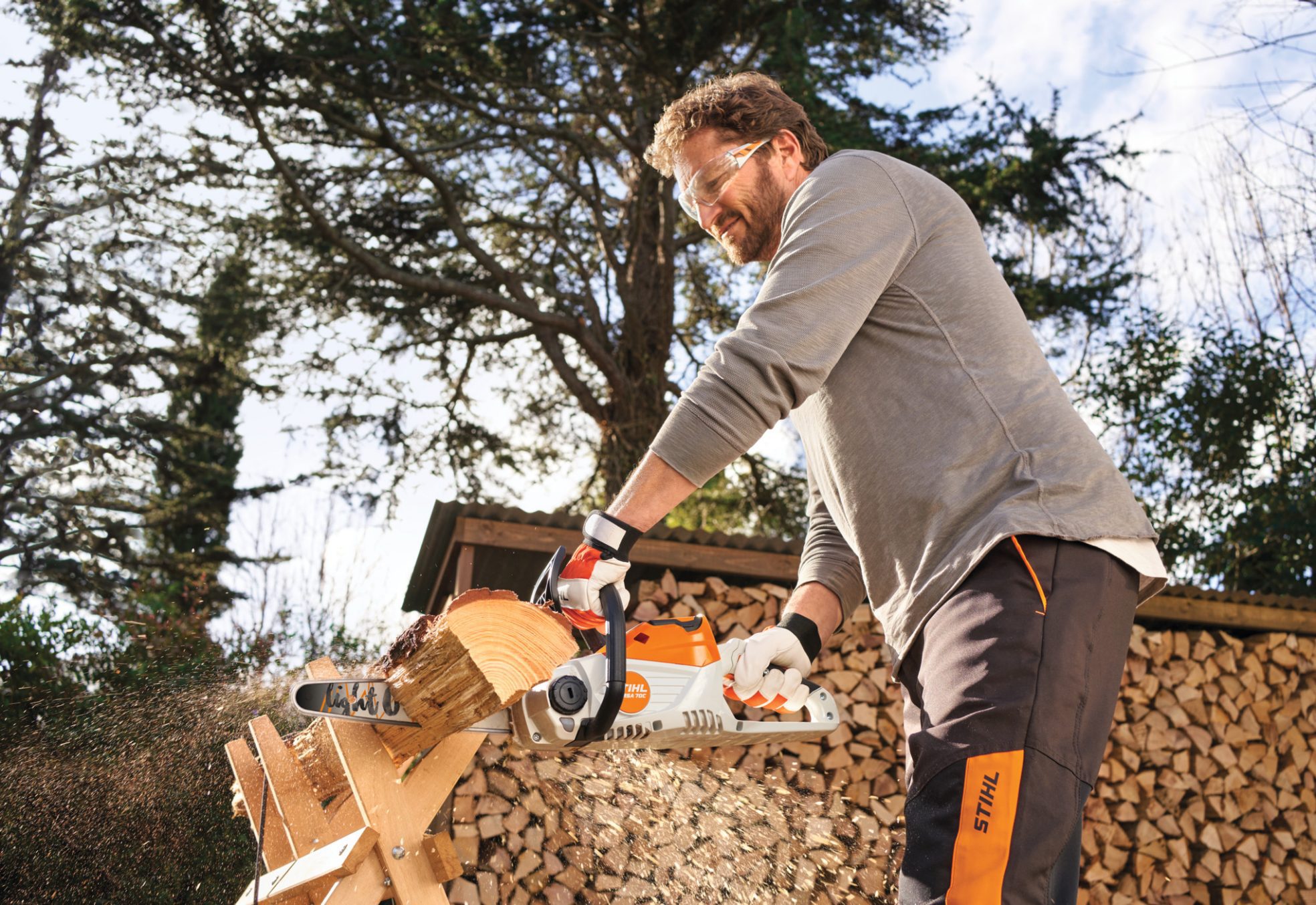 Man cutting wood with a STIHL chainsaw